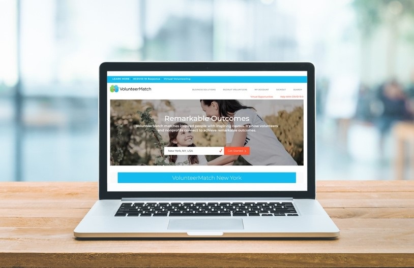 An open laptop with the VolunteerMatch website displayed on the screen.